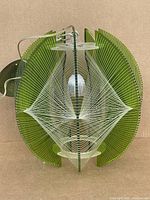 Full view of Lucite panel and string light fixture upright with cord and canopy