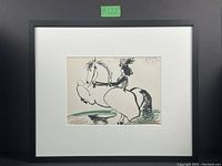 Framed Picasso lithograph showing the full artwork, matting, and black frame with identification label #122.