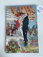 Front cover of X-Men comic book issue 30 showing Scott Summers and Jean Grey at their wedding with other X-Men characters around.