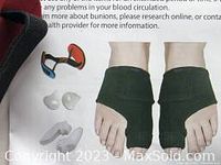 Two black adjustable bunion braces shown being worn on feet, with white silicone toe pads and instructions visible.