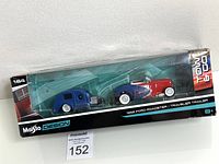 Clear view of unopened box containing 1932 Ford Roadster and matching Traveler trailer diecast models by Maisto Design in 1:64 scale.