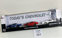 Front view of the unopened box containing three Today's Chevrolet Camaro IROC-Z diecast models in blue, red, and white.