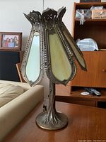 Full view of the antique lamp showing bronze tree base and stained glass shade