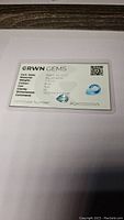 Certification card for aquamarine gemstone showing brand GRWN GEMS, cert date March 18, 2023, aquamarine, weight 1.90ct, blue color, pear cut, VS clarity, dimensions 10.3 x 7.3mm, certificate number AQA000005VS