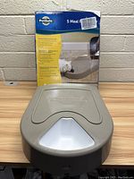Photo showing PetSafe 5 Meal Automatic Pet Feeder in front of the box with text and image of a cat on the box.
