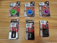 Front view of six Master locks in original packaging showing three dial combination locks and three resettable combination locks.
