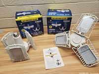 Two Bright Living Multi-Directional LED Light boxes with two assembled LED bulbs showing the three adjustable panels and E26 screw base.