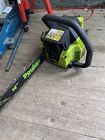 Side view of the Poulan 2050 chainsaw showing the bar marked 'Poulan' and the general shape and color of the unit.
