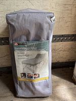 Gray carry bag for Ozark Trail framed inflatable airbed with product label showing product features and usage images.