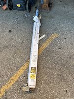 Full length view of the boxed Jack Post on asphalt showing packaging condition and labels.