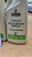 Close-up of a single bottle showing the Natural Chemistry brand and product details for flea and tick spray.