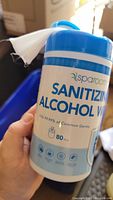 Front container label showing Sparoom brand, 'Sanitizing Alcohol Wipes', containing 80 wipes, kills 99.99% of common germs.