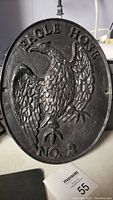 Front of the oval vintage metal sign showing eagle relief and text EAGLE HOSE NO 2