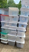 Photo showing stacks of plastic storage tubs of various sizes and colors including transparent, white, and colored lids.