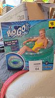 Box packaging of H2O Go! Glitter Dream Swim Tube showing image of woman using the tube in a pool and branding.