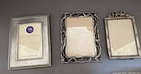 All three pewter picture frames together showing different designs and glass covers