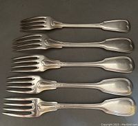 Four matching French silver plated forks arranged side by side showing their heart-shaped decorative handle ends and polished finish.