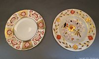 Two Royal Crown Derby bread plates showing different Imari floral designs and gold accents.
