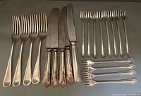 Complete set of 4 Mappin & Webb forks, 8 Rogers cocktail/seafood forks with beaded handles, and 6.5 cutting knives with mixed handle designs