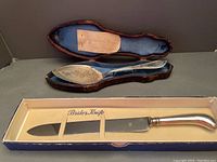 Victorian silver plated cake server with engraved floral detail in fitted leather box