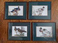 Group photo showing all four metal-framed waterfowl art prints by Art LaMay, double matted under glass.