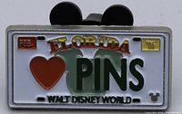 Front view of Disney WDW license plate style pin with heart and 'PINS' wording, dated Feb 2006