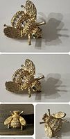 Front and side views of a gold tone bee brooch showing textured wings and body with clear rhinestones and green stones for eyes.