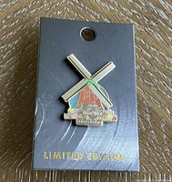 Collector pin featuring windmill design on black card with limited edition text.