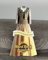 Single collector pin showing a vintage long dress design with Hard Rock Hotel & Casino logo and 2008 People's Princess Tour text