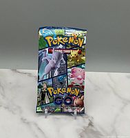 One sealed Pokemon GO trading card pack with colorful artwork featuring Mewtwo, Pikachu, Blissey, and other characters