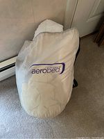 Aerobed branded white storage bag or cover with logo visible