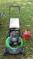 Full front view of Lawn Boy gas powered lawn mower and 2 gallon gas can on grass.