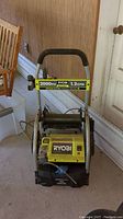 Front view of the pressure washer showing frame, handlebar, and capacity sticker.