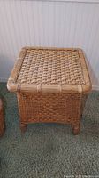 Front and side view of square wicker style end table showing woven wicker top and basket weave sides.
