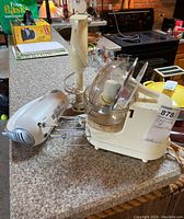 Photo showing all three kitchen appliances on a counter: Sunbeam Oskar Plus food processor, Betty Crocker hand mixer, and immersion blender grouped together.