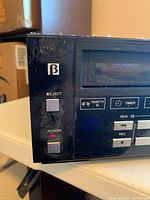 Close-up of Sanyo Beta Hi-Fi cassette player with eject and power buttons, Beta symbol visible.