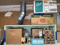 Boxes containing assorted canning jars, lids and bands with packaging noted