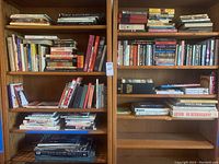 Photo of large bookshelf packed with various books, including visible titles of photography and comic collections
