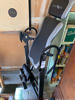 Full side view of the Innova inversion table showing padded backrest, headrest, arm handles, and foot holding mechanisms.