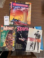 Six magazines fanned: Science Fiction Review (pink cover), Science Fiction Chronicle (black topband), Famous Monsters of Filmland, Starlog, Steed & Mrs Peel