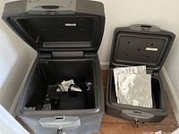 Two Sentry safes open showing interior storage space and lock mechanism with keys attached