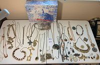 Overview of all necklaces, decorative peacock box, and bag of components