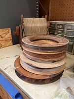 Photo showing wooden spools with various types of wire or fishing line wound on them.