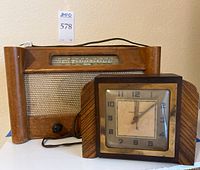 Radio and clock together showing wood finish and fabric front of radio and square face of clock