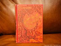 Front cover of the red hardcover book with gold embossed title and thematic illustration regarding the Klondyke gold fields.