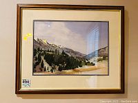Framed watercolour painting of a mountain landscape with forest and river valley, signed by JP Walters.