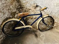 Side view of the vintage Dunelt child's bicycle showing blue frame, cream fenders, brown leather seat, and handlebar grips.