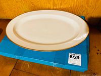 Top view of the 24-inch porcelain platter showing the oval shape and gold rim