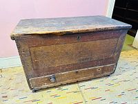 Front view showing rectangular chest, drawer with knob, original paint and overall wear