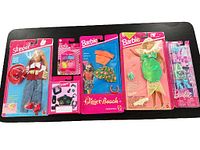 Lot of Barbie and Skipper doll outfits and accessories, all sealed in original packaging with some visible wear on the packaging. Items include western Skipper outfit, beach Barbie clothing, mermaid outfit, and small accessory packs.